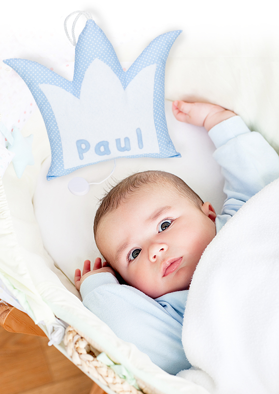 Portrait of a bright baby lying in his cradle
